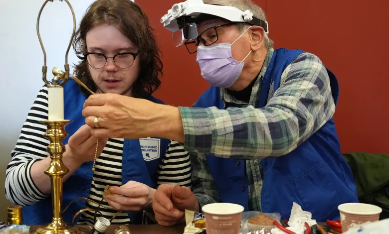 Caleb Ihla got help from his grandfather Rod Basham as he fixed a lamp Saturday during a Ramsey County Fix-It Clinic at the Ramsey County Library