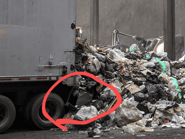Sept. 8th 2022, from my visit at the Hennepin County Energy Recovery Center. The circled part of the Image is a microwave coming off of a waste hauling truck, being dumped into the pit, where it will get picked up and loaded into the incinerator. 