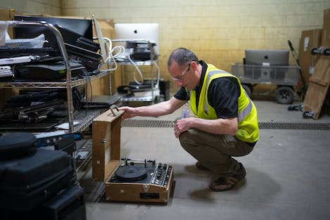 In the intake sorting area, Luke Kragenbrink, an environmental health and safety specialist, looked at a portable record player that Repowered’s St. Paul collection site had recently acquired.
